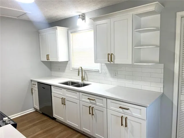 a kitchen with white cabinets and a sink