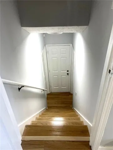 a view of a room with wooden floor and a window
