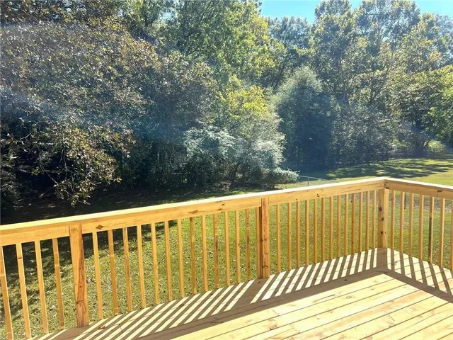 a view of balcony with wooden floor and fence