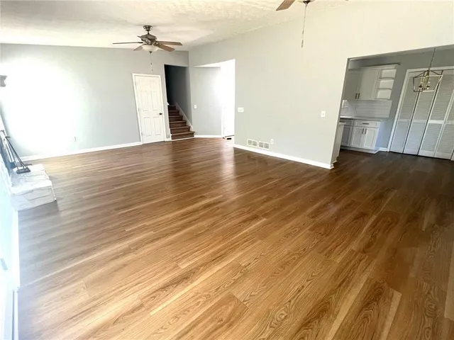 a view of a room with wooden floor