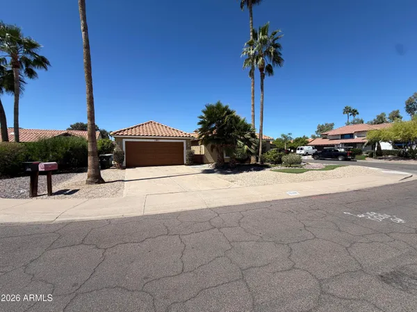 a front view of a house with a garden and yard
