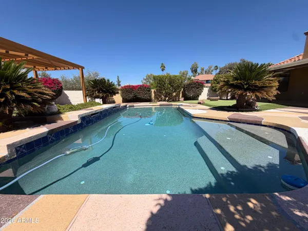 a view of a swimming pool with outdoor seating