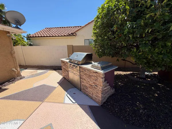 a terrace with outdoor seating and wooden fence