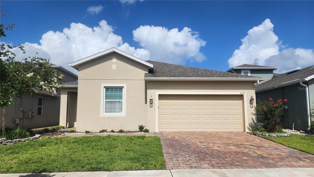 3230 Stratton Circle Kissimmee, FL 34744 - Photo 1 of 28 a front view of a house with a yard and garage