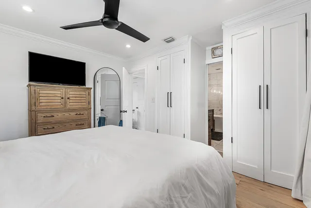 a bedroom with a large bed and a window