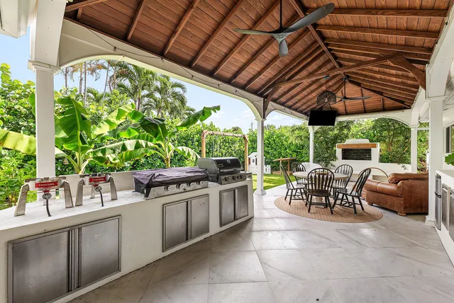 a outdoor living space with furniture potted plant and a large window