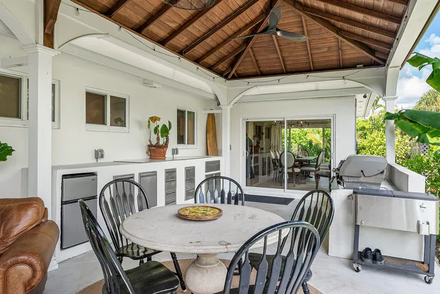 a view of a porch with furniture and a yard