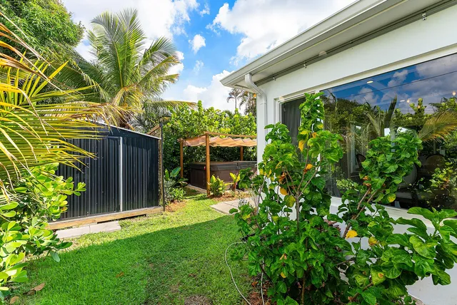 an aerial view of a house with a garden and swimming pool