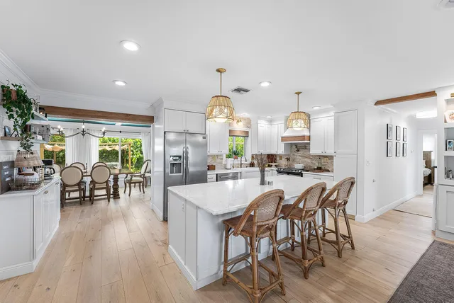 a large kitchen with a table and chairs