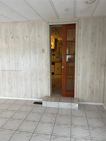 a large kitchen with stainless steel appliances a counter space and cabinets