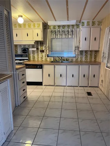 a kitchen with granite countertop a stove and a cabinets