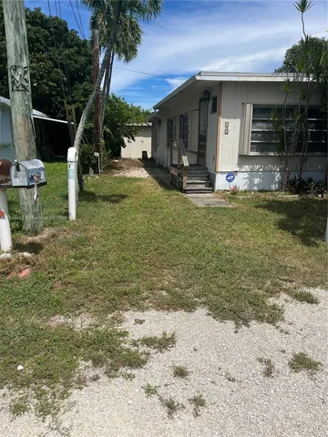 a view of a house with backyard porch and sitting area