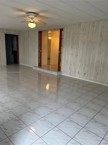 a view of an empty room and a window