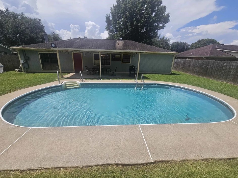 207 Thorn Ridge Street Bridge City, TX 77611 - Photo 16 of 19 a view of a house with a swimming pool and a yard
