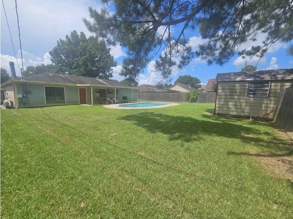 207 Thorn Ridge Street Bridge City, TX 77611 - Photo 17 of 19 a view of a house with backyard and trees