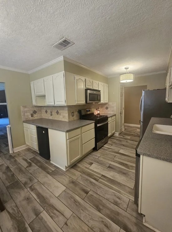 207 Thorn Ridge Street Bridge City, TX 77611 - Photo 4 of 19 a large kitchen with stainless steel appliances granite countertop a stove a sink dishwasher and a refrigerator