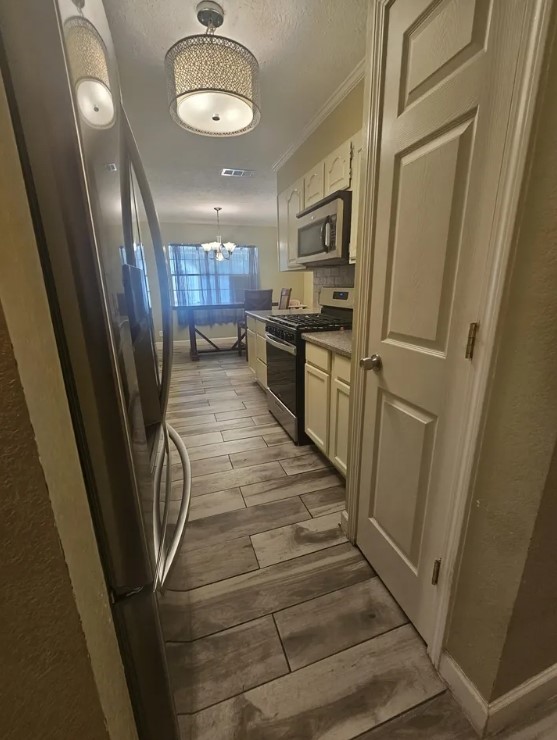 207 Thorn Ridge Street Bridge City, TX 77611 - Photo 5 of 19 a view of a kitchen from the hallway