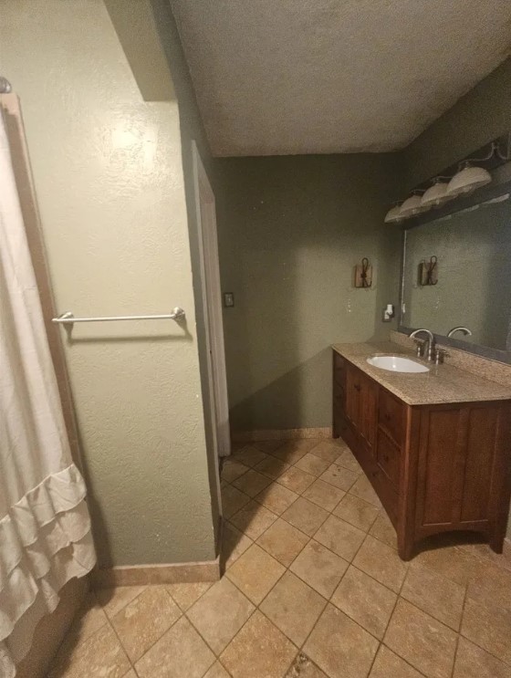 207 Thorn Ridge Street Bridge City, TX 77611 - Photo 10 of 19 a bathroom with a sink a mirror and a shower