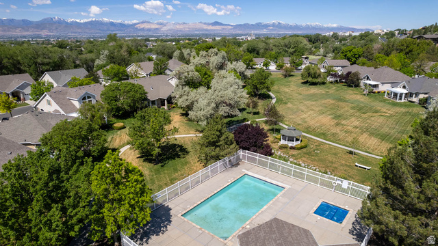1417 Blacksmith Lane Draper, UT 84020 - Photo 56 of 57 Community swimming pool with an integrated spa, surrounded by a white fence and extensive green spaces