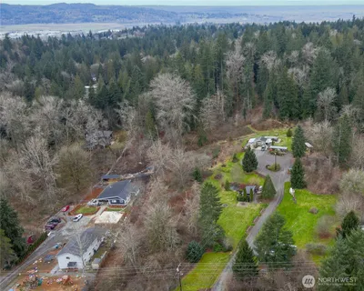 an aerial view of a house with a yard