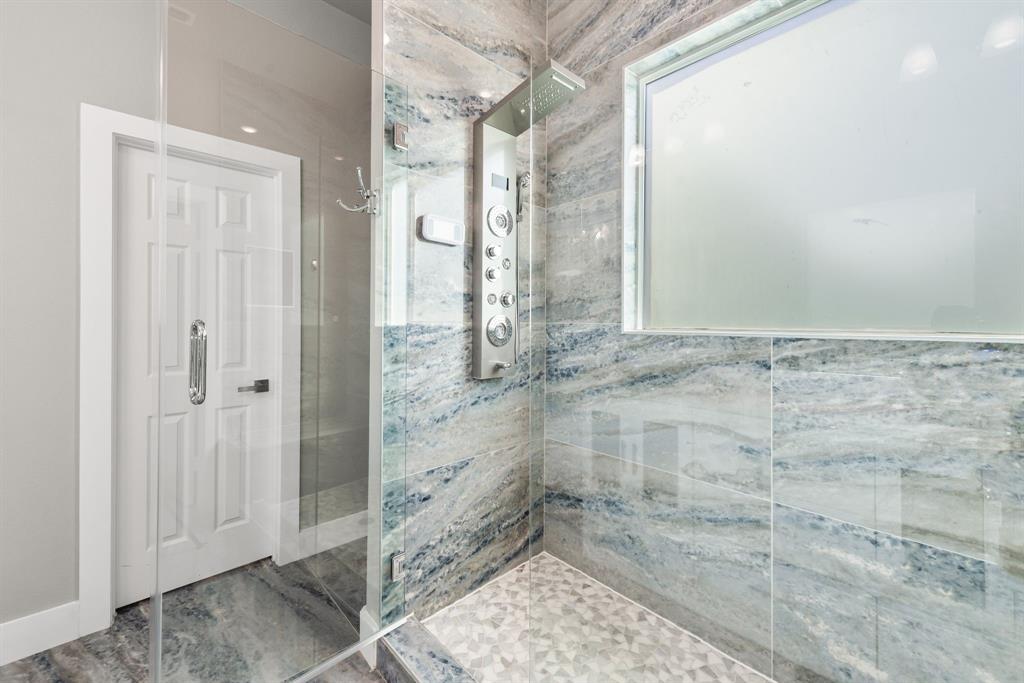 13032 Rudy's Way Streetman, TX 75859 - Photo 22 of 40 Full bathroom with walk-in shower, tile accents, and clean modern design.