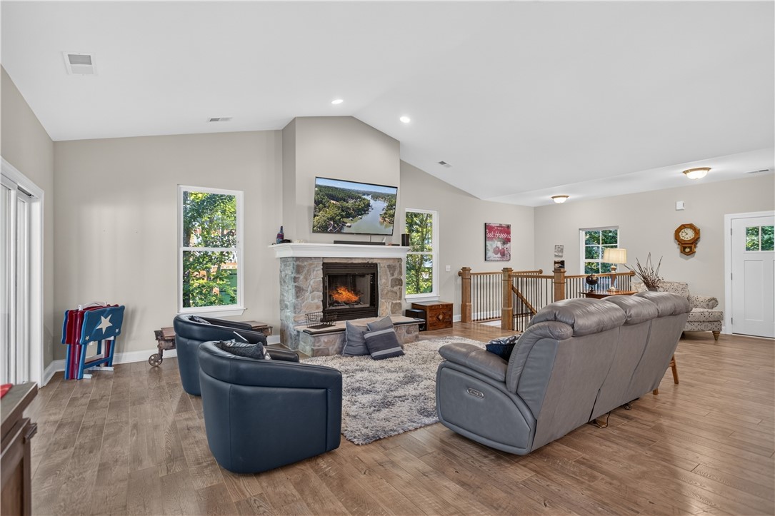 321 High Hampton Road Salem, SC 29676 - Photo 5 of 46 Vaulted ceilings and a stone fireplace define this inviting living area featuring rich wood flooring.