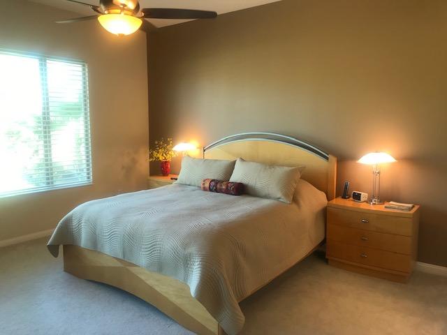 81194 Avenida Sombra Indio, CA 92203 - Photo 13 of 24 a bedroom with a bed and lamp