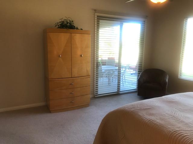 81194 Avenida Sombra Indio, CA 92203 - Photo 14 of 24 a bedroom with a bed and a window
