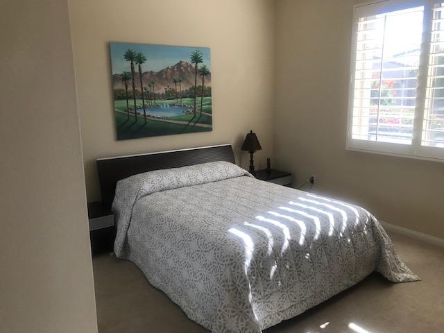 81194 Avenida Sombra Indio, CA 92203 - Photo 18 of 24 a bed sitting in a bedroom next to a window