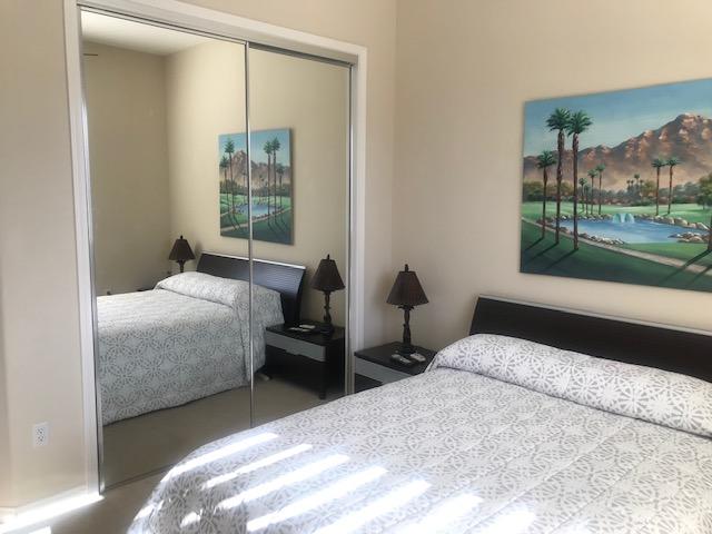 81194 Avenida Sombra Indio, CA 92203 - Photo 19 of 24 a bedroom with a bed and a large window