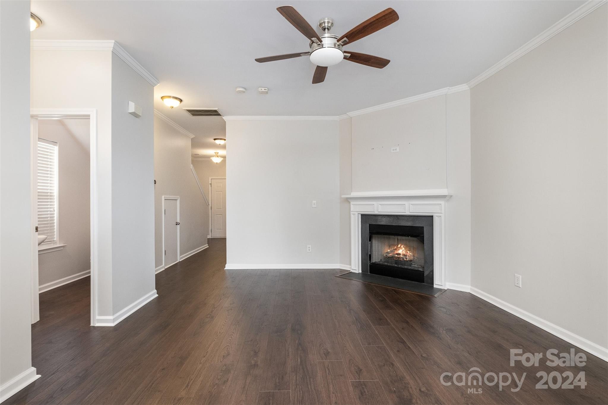 2149 Midnight Blue Lane Fort Mill, SC 29708 - Photo 11 of 30 an empty room with wooden floor a fireplace