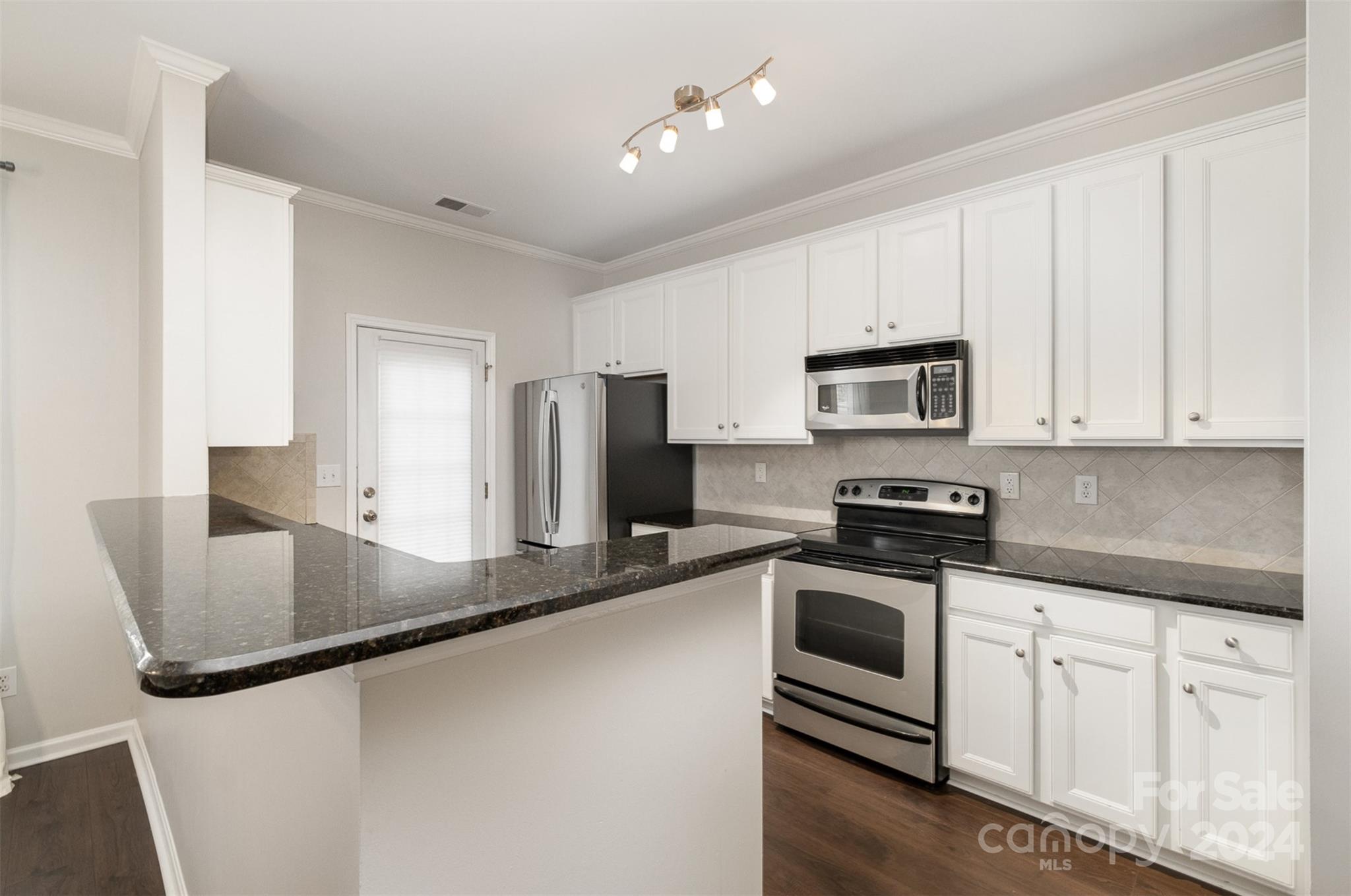 2149 Midnight Blue Lane Fort Mill, SC 29708 - Photo 12 of 30 a kitchen with stainless steel appliances granite countertop white cabinets a refrigerator a sink a stove and white cabinets
