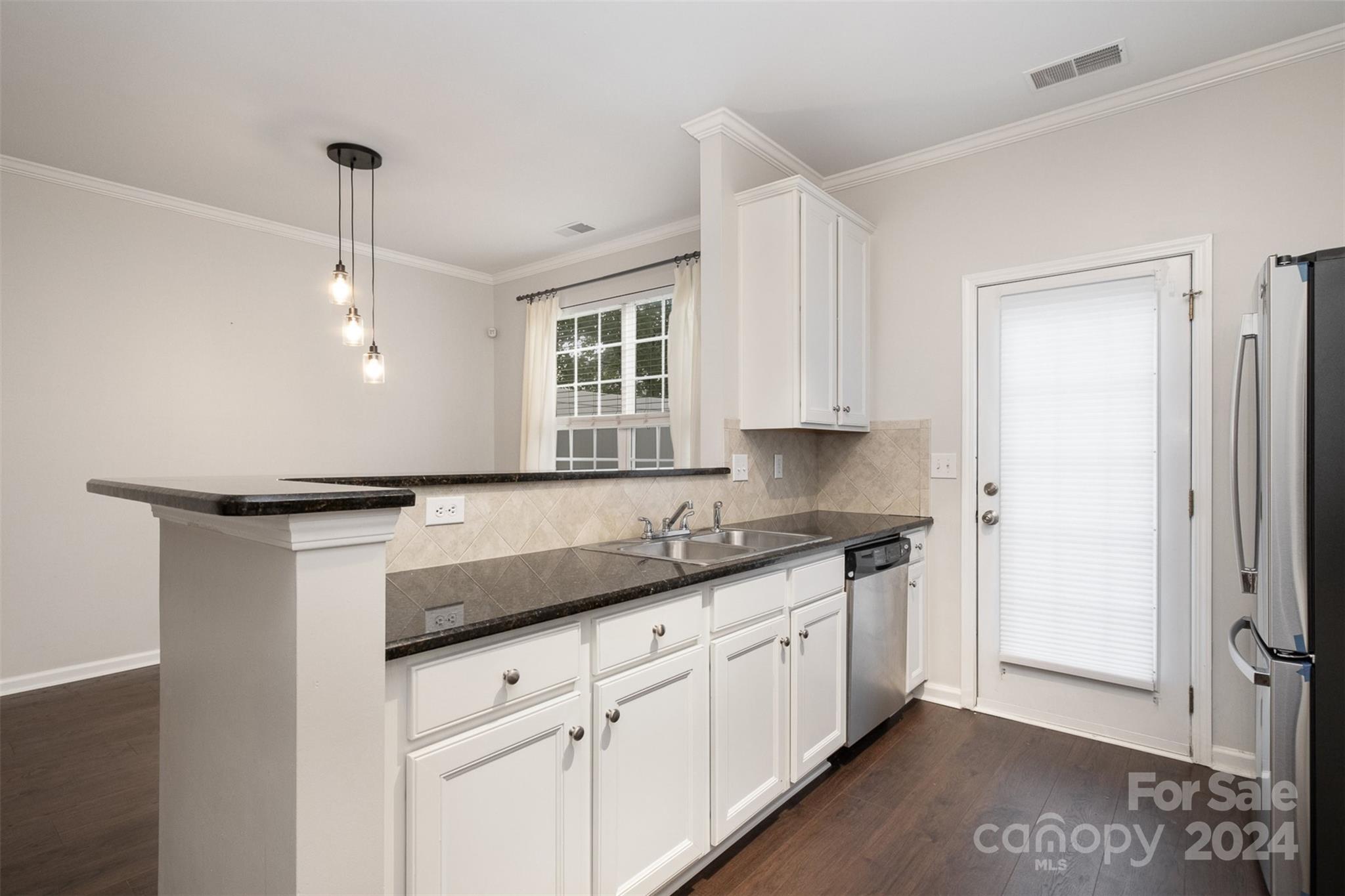 2149 Midnight Blue Lane Fort Mill, SC 29708 - Photo 13 of 30 a kitchen with granite countertop a sink stainless steel appliances and cabinets