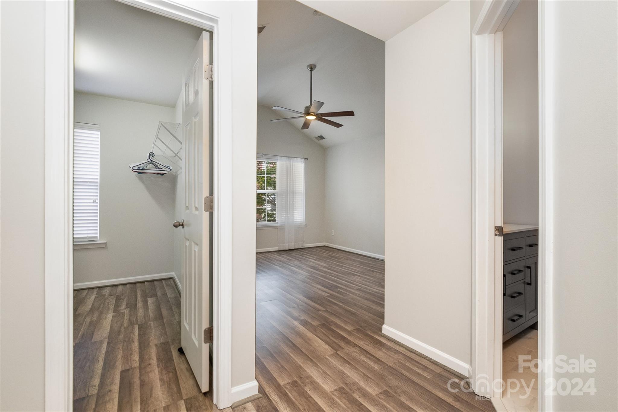 2149 Midnight Blue Lane Fort Mill, SC 29708 - Photo 17 of 30 a view of a hallway with wooden floor and a livingroom with furniture