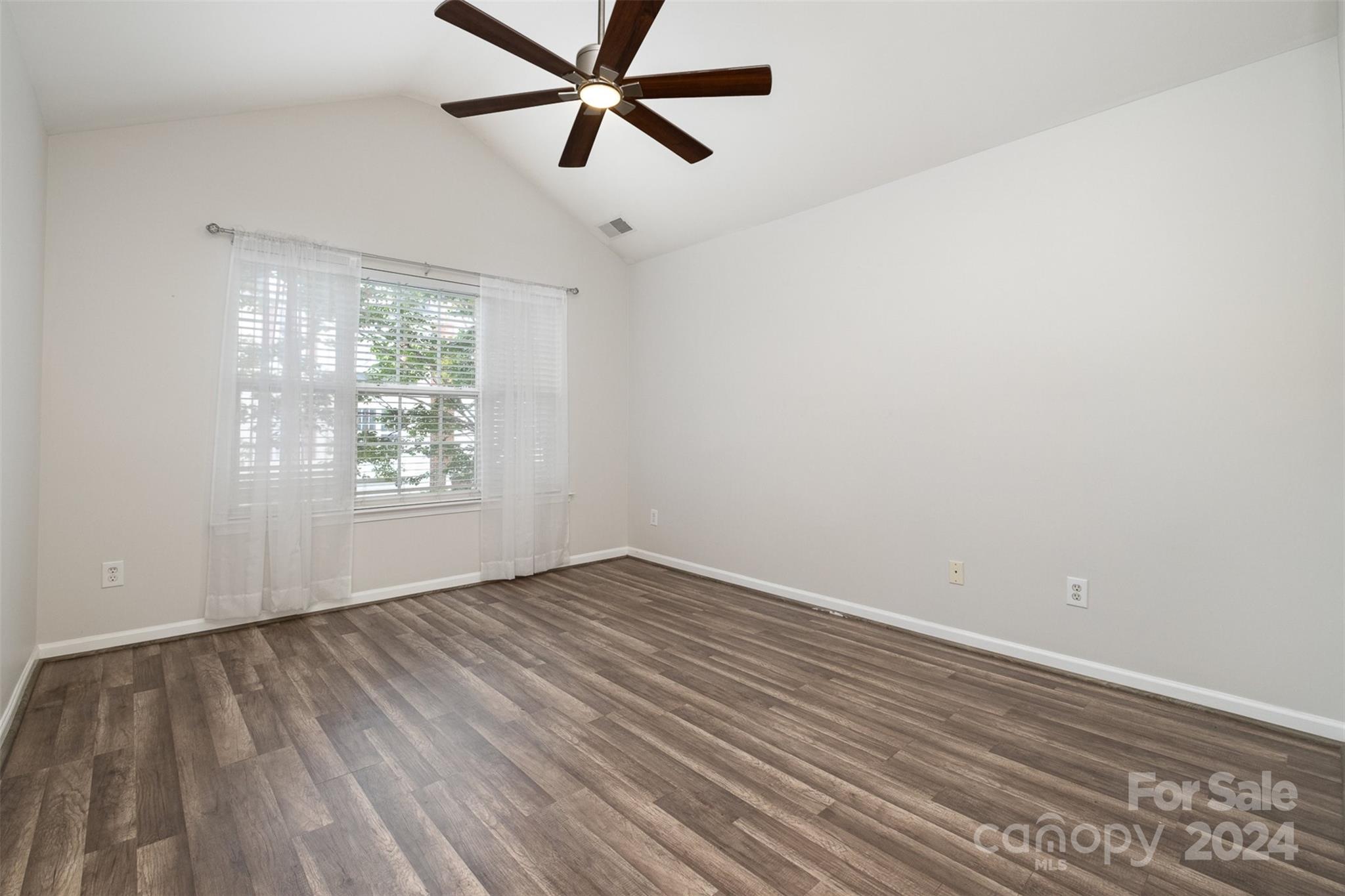 2149 Midnight Blue Lane Fort Mill, SC 29708 - Photo 19 of 30 an empty room with wooden floor and windows