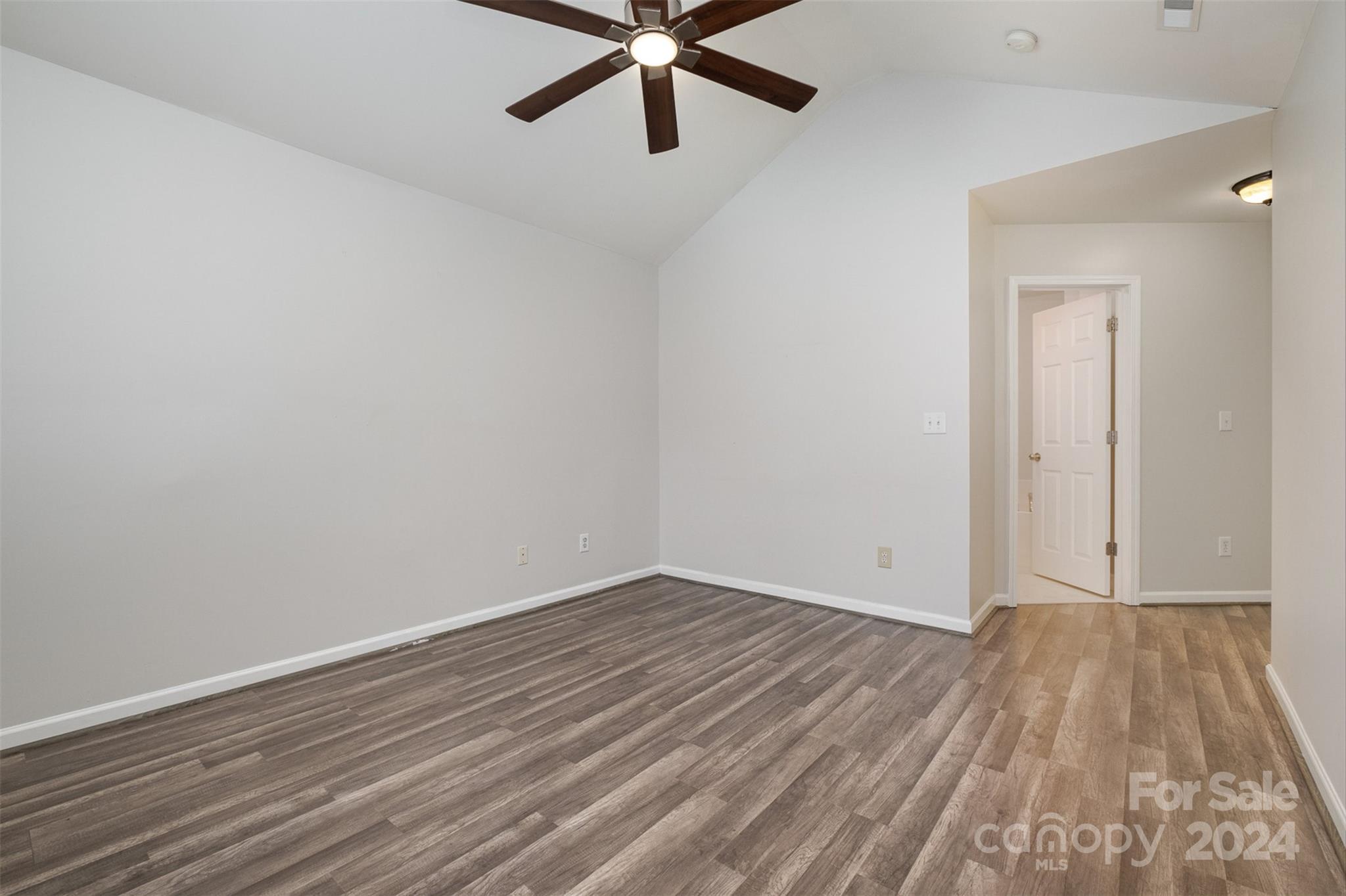 2149 Midnight Blue Lane Fort Mill, SC 29708 - Photo 20 of 30 an empty room with wooden floor and a ceiling fan