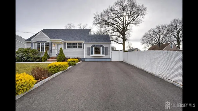 a view of a house with a large tree in front of it