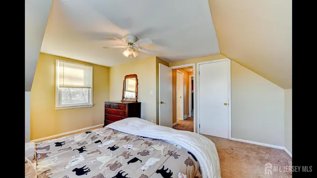 a bedroom with a bed dresser and a window