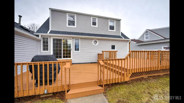 a view of a balcony with wooden floor and outdoor seating