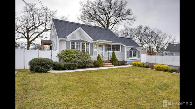 a front view of house with yard and trees around