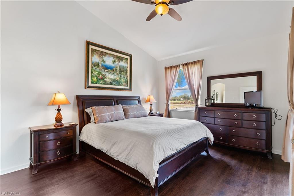 6693 Alden Woods Circle, Unit 202 Naples, FL 34113 - Photo 19 of 25 a bedroom with a bed and a dresser next to a window