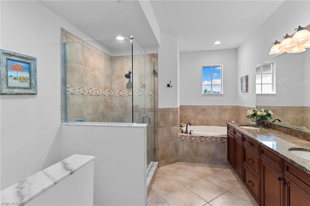 6693 Alden Woods Circle, Unit 202 Naples, FL 34113 - Photo 20 of 25 a bathroom with a bathtub shower sink mirror and toilet