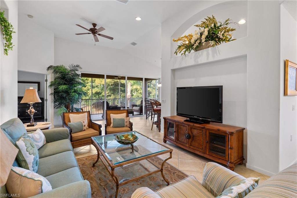 6693 Alden Woods Circle, Unit 202 Naples, FL 34113 - Photo 2 of 25 a living room with furniture and a flat screen tv