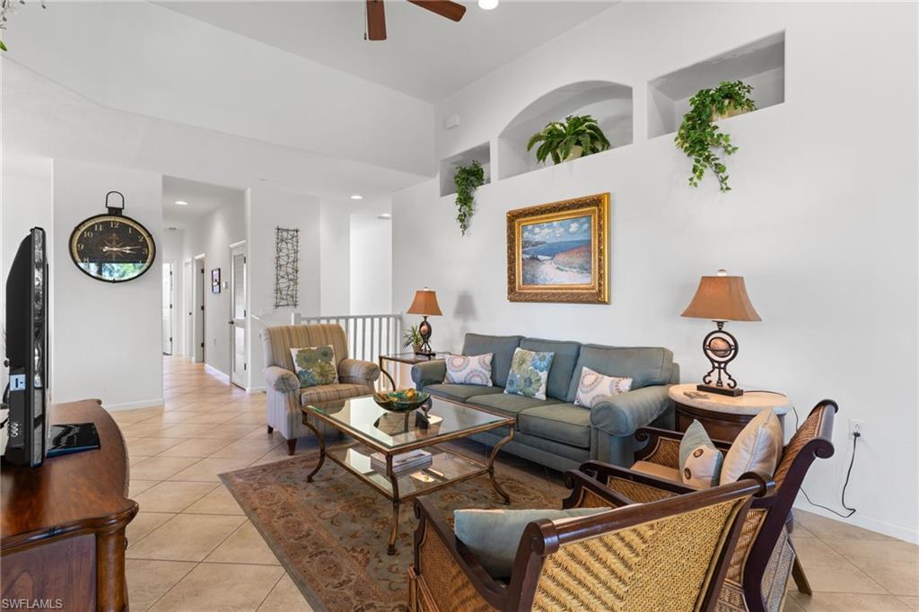 6693 Alden Woods Circle, Unit 202 Naples, FL 34113 - Photo 8 of 25 a living room with furniture and wooden floor