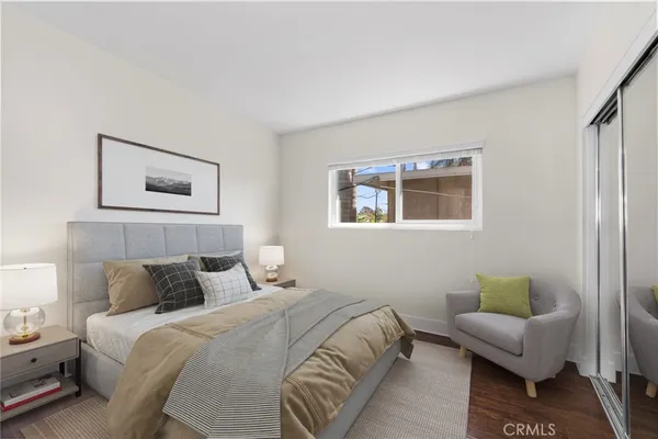 a bedroom with a bed and a couch