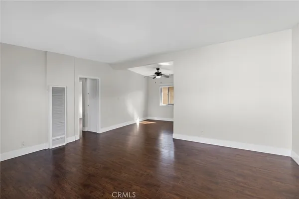 a view of a room with wooden floor