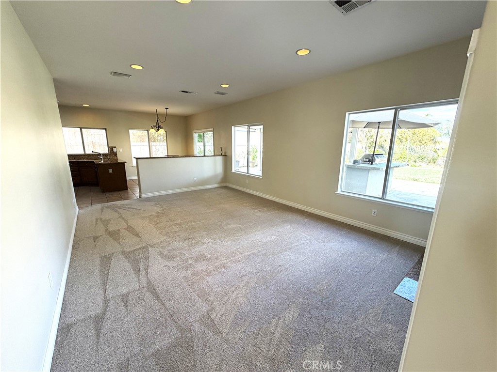 873 Greenridge Road Corona, CA 92882 - Photo 11 of 30 a view of an empty room with a window and a kitchen