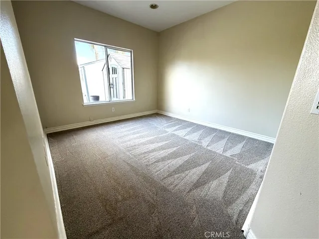 a view of livingroom with window and hallway with windows