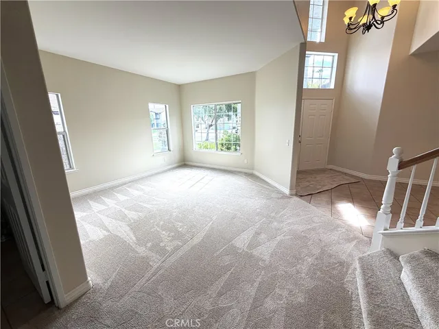 a view of a house with a patio and a yard