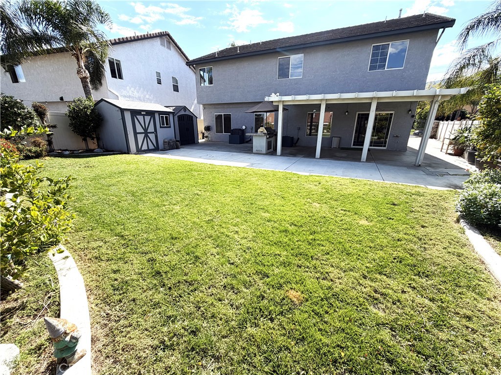 873 Greenridge Road Corona, CA 92882 - Photo 17 of 30 a view of a house with a patio and a yard